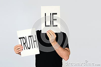 Man holding two cards with the words Lie and Truth Stock Photo