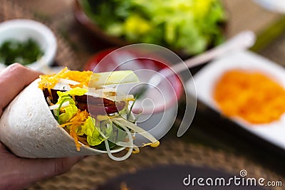 man holding typical Mexican fajita with shrimp and vegetables Stock Photo