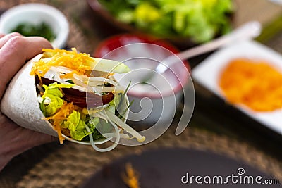 man holding typical Mexican fajita with shrimp and vegetables Stock Photo