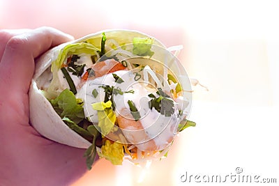 man holding typical Mexican fajita with shrimp and vegetables Stock Photo