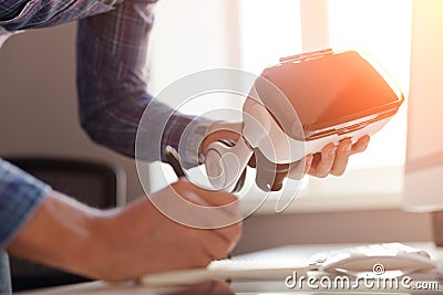 Man holding VR headset and writing Stock Photo