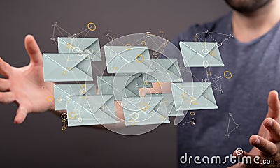 Man holding a web of illustrative 3D rendered envelope icons in the air Stock Photo