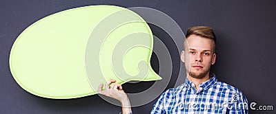 Man holding white blank speech bubble with space for text, Stock Photo