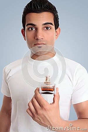 A man holds a bottle of cologne Stock Photo