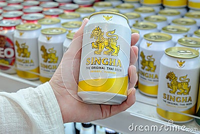 Man holds a can of popular Thai beer Singha in his hand Editorial Stock Photo