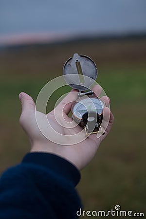 Man holds a compass in his hand. man wathing compass holding in his hands Stock Photo