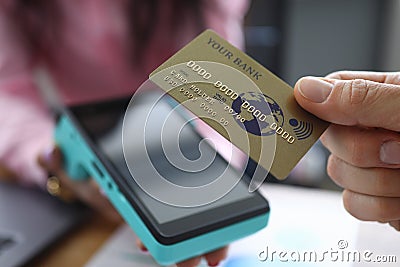 Man holds credit card with PayPass technology Stock Photo