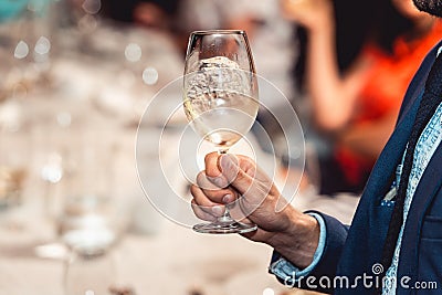 Man holds glass of red wine. people consider the color of the wine and try how it smells in different glasses Stock Photo