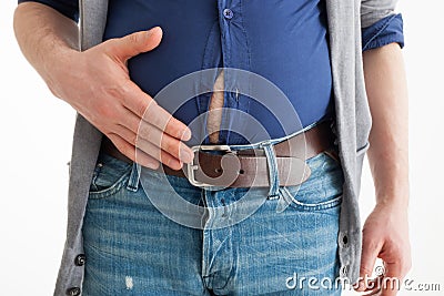 The man holds his hand over his swollen abdomen Stock Photo