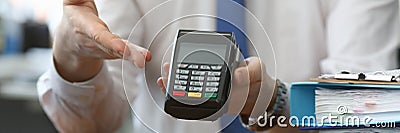 Man holds his hand wireless terminal for payment Stock Photo