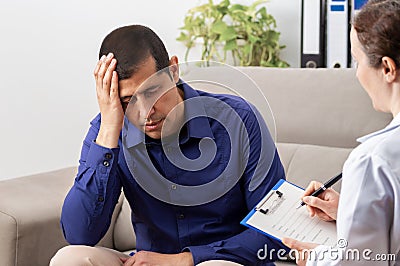 Man holds his head Stock Photo