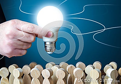 A man holds an idea light bulb above the crowd. Project leader. Teamwork. Brainstorming. Creativity. Informant. Statistics, survey Stock Photo