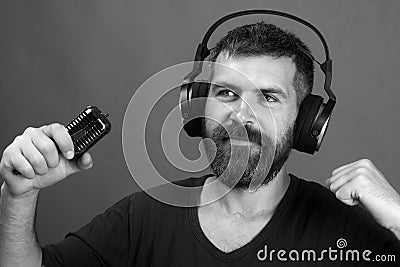 Man holds microphone on green background. Relax and music concept. Stock Photo