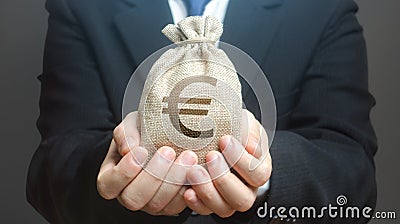 A man holds out a euro money bag. Granting financing business project or education. Provision cash financial loan credit. Stock Photo