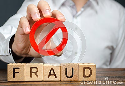 A man holds a red NO prohibition symbol over word fraud. Countering deception, protection against fraudsters. The fight corruption Stock Photo