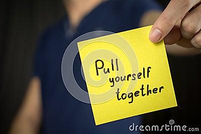 Man holds yellow sticker inscription Pull yourself together Stock Photo