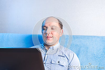 Man at home in front of laptop. During online communication, an idea. An idea came up during online communication Stock Photo