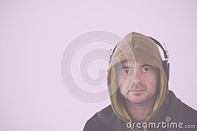 Man in hoodie listening to headphones Vintage Retro Filter. Stock Photo