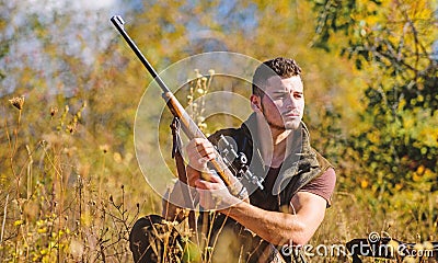 Man hunting wait for animal. Hunter with rifle ready to hunting nature background. Hunting strategy or method for Stock Photo