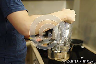 man husband pouring water filter to pot cooking at home family kitchen together help meal dinner Stock Photo