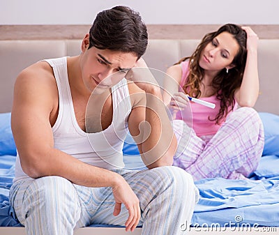 Man husband upset about pregnancy test results Stock Photo