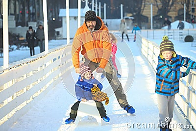 Man ice skating with son Editorial Stock Photo