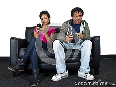 Man ignoring girlfriend while playing video games Stock Photo