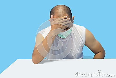 Man image Stressed tired freelancer is having headache and thinking about how to finish his work. He is in a casual smart, Stock Photo