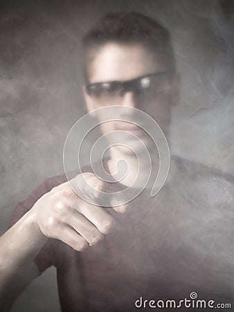 Man indicated in a cloud of smoke Stock Photo
