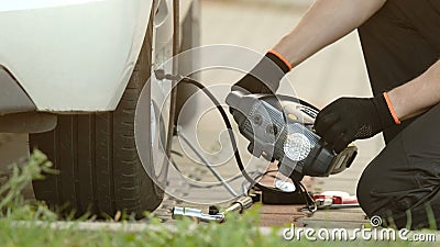 Man Inflates Tire Stock Photo