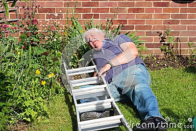 Man injured after falling from a ladder. Stock Photo