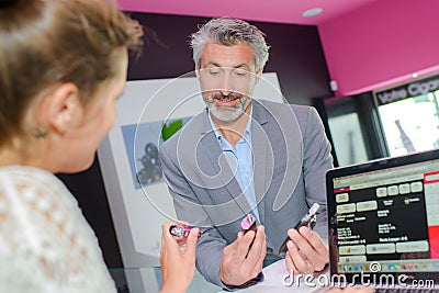 Man and inquiry in boutique Stock Photo