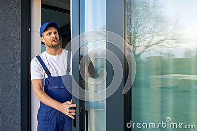 man installing aluminum frame sliding terrace doors Stock Photo