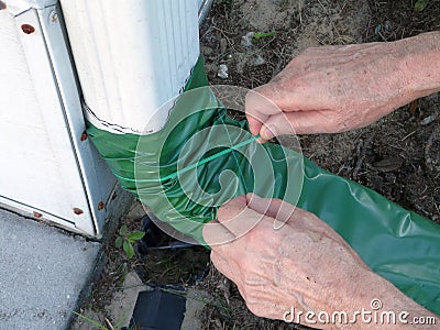 Man Installing Gutter Downspout Retractable Extender Stock Photo