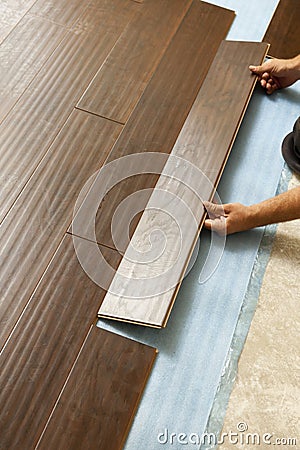 Man Installing New Laminate Wood Flooring Stock Photo