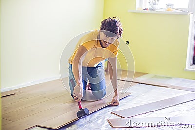 Man installing new wooden laminate flooring. infrared floor heat Stock Photo