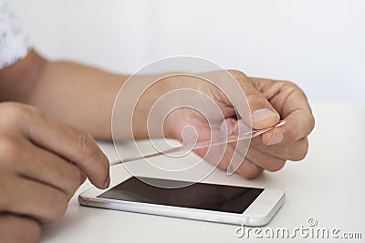 Man installing a screen protector in a smartphone Stock Photo