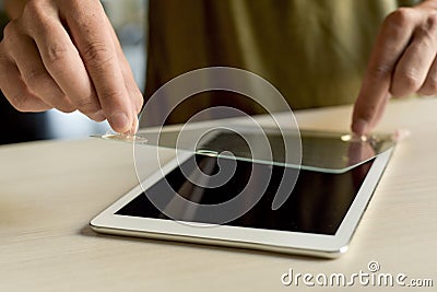 Man installing a screen protector in a tablet Stock Photo