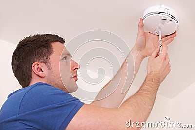 Man Installing Smoke Or Carbon Monoxide Detector Stock Photo