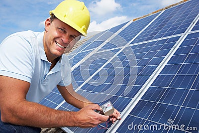 Man installing solar panels Stock Photo