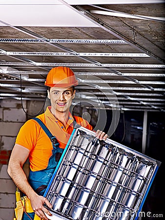 Man installing suspended ceiling Stock Photo