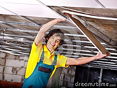 Man installing suspended ceiling Stock Photo