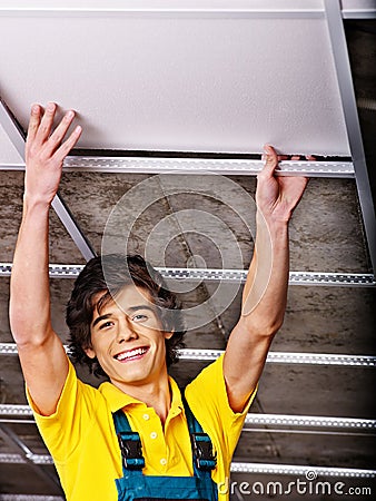 Man installing suspended ceiling Stock Photo