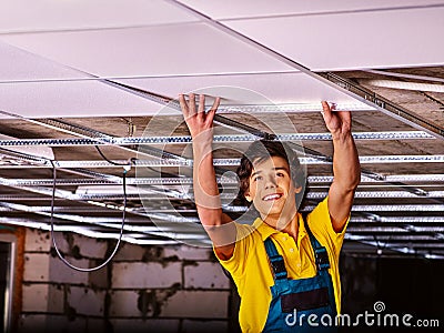 Man installing suspended ceiling Stock Photo