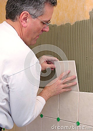 Man installs ceramic tile Stock Photo