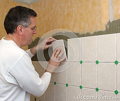 Man installs ceramic tile Stock Photo