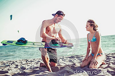 Man instructor teaches the girl in kite surfing Stock Photo