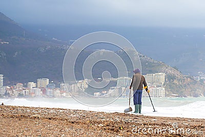 Man look for old historical values since war ancient coins with metal detector Stock Photo