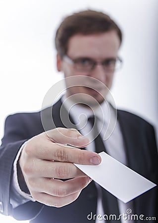 Man in jacket handing bussines card Stock Photo