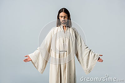 Man in jesus robe standing with outstretched hands Stock Photo